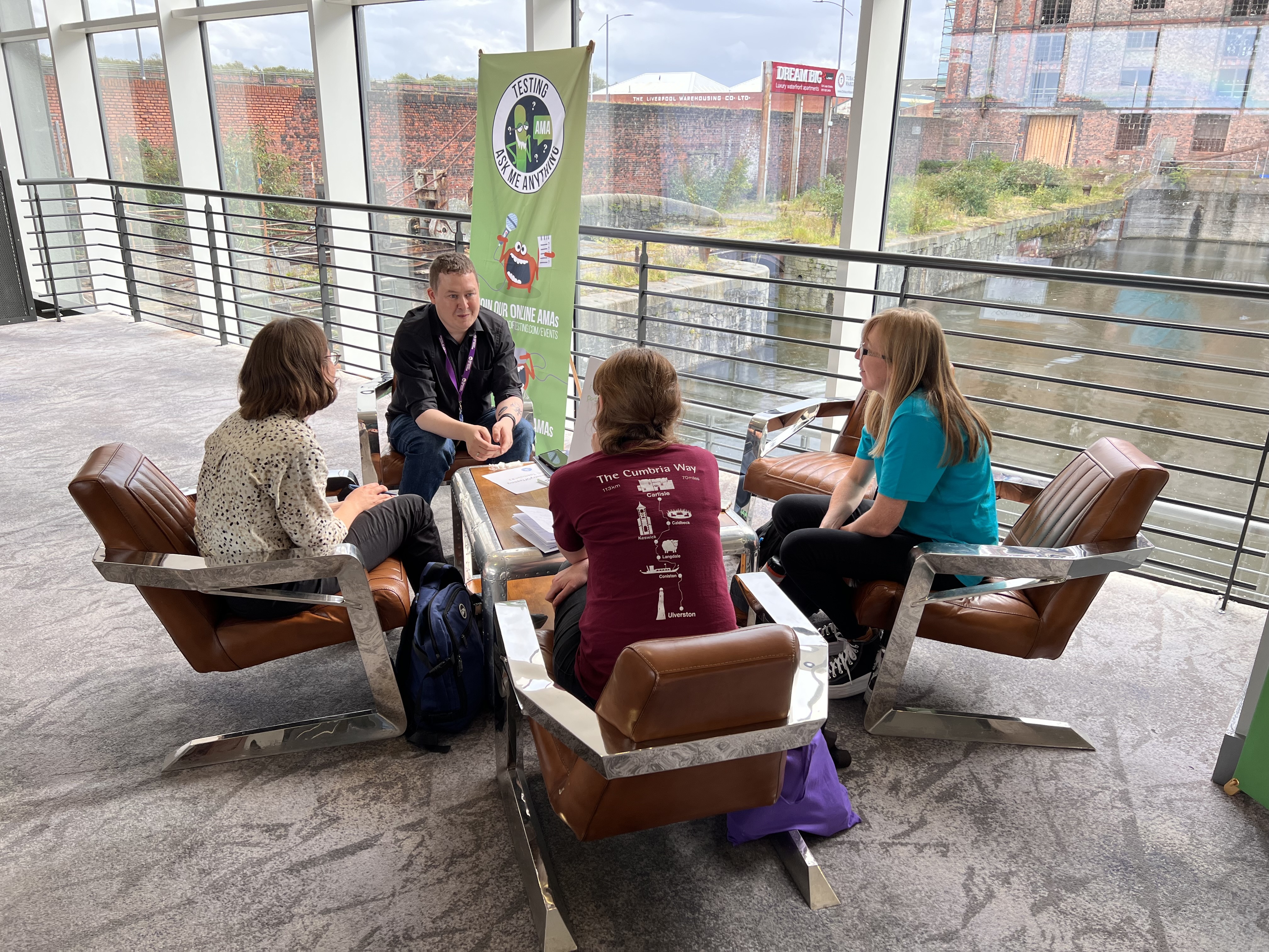 Four people gathered round a table having a deep discussion